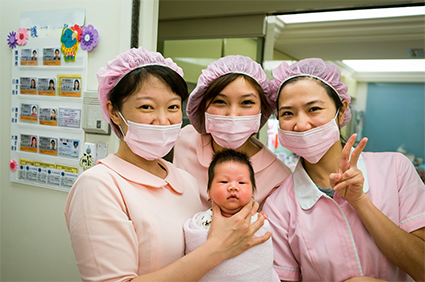 nurses with a newborn baby