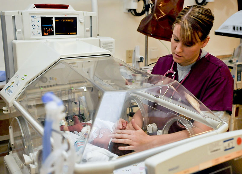 nurse examining infant