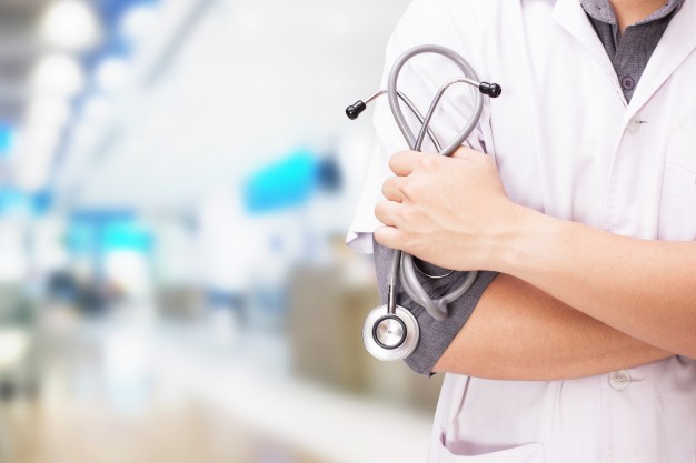 doctor with stethoscope hands hospital background